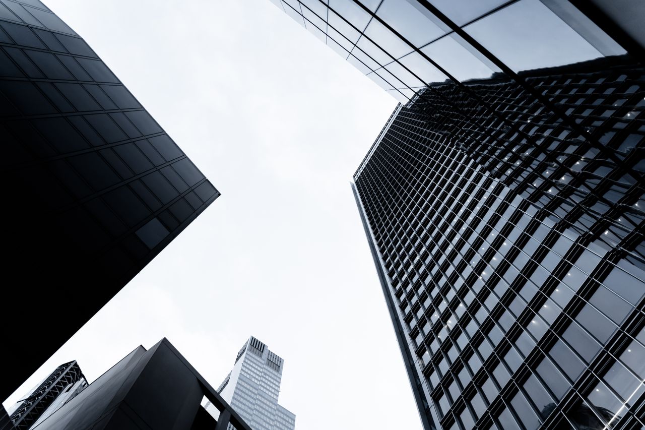 Services Low angle view of tall skyscrapers against the sky in London, showcasing modern architecture.