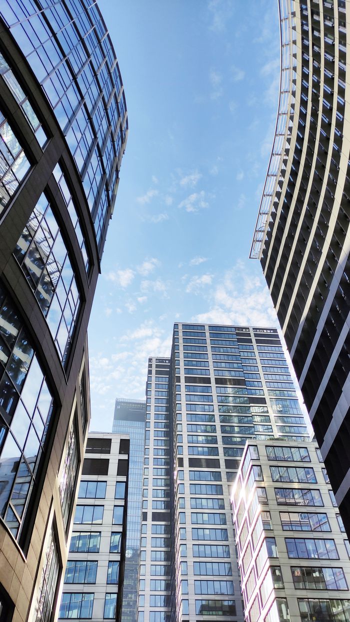 A stunning view of modern skyscrapers against a clear blue sky in Warsaw, Poland.