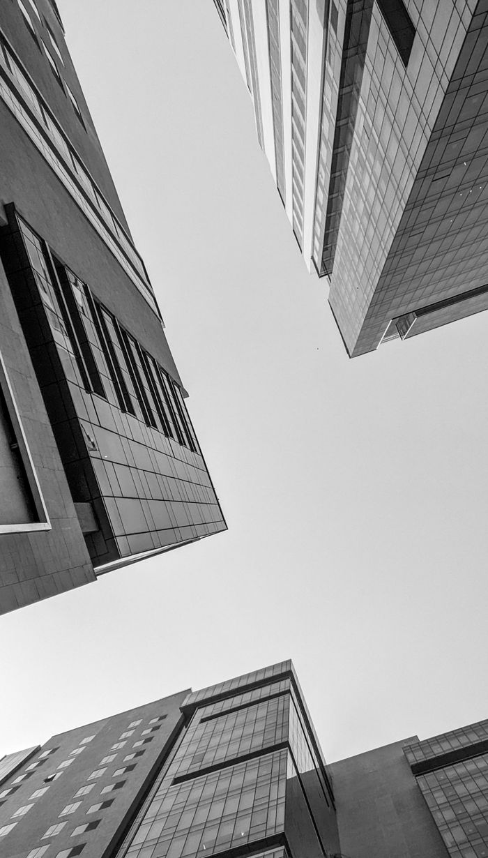 Services Low angle view of contemporary city buildings under a clear sky.