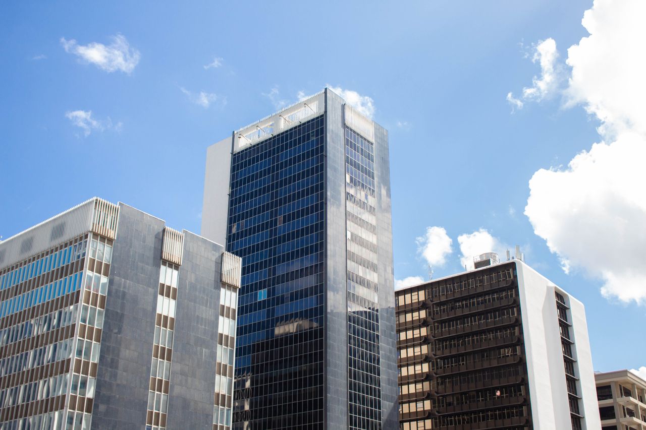 Home Contemporary high-rise buildings in Puerto Rico's cityscape under a bright blue sky.
